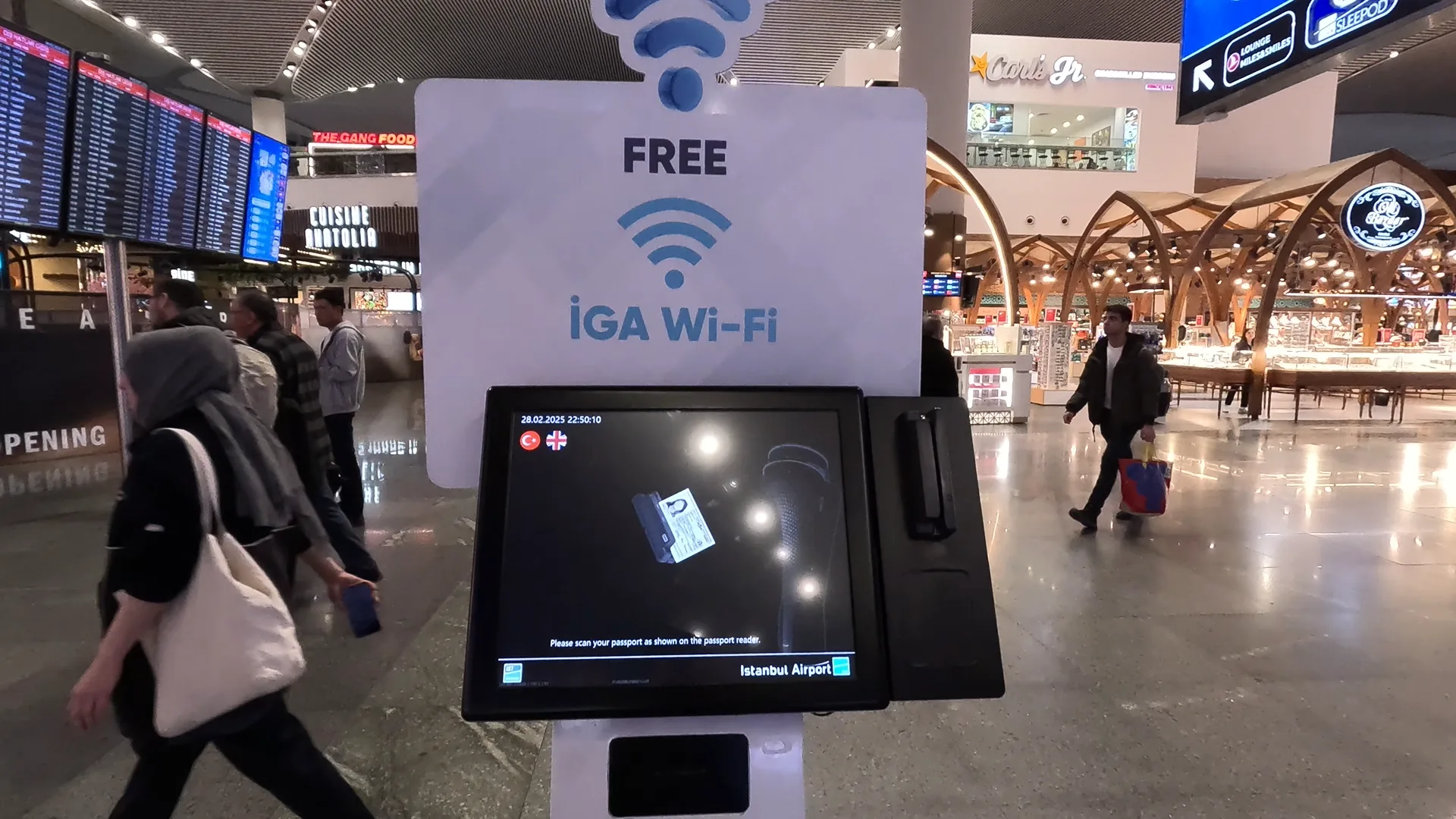 Istanbul Airport free wifi stand. A screen asks passengers to scan their passport to get free wifi.