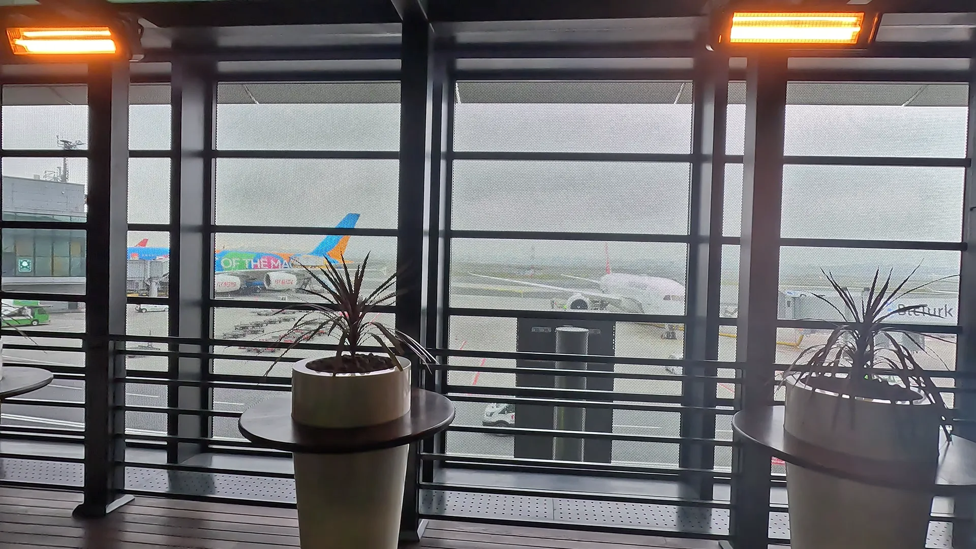 View of planes, airport vehicles and runways from the Istanbul Airport Fresh Air Terrace.