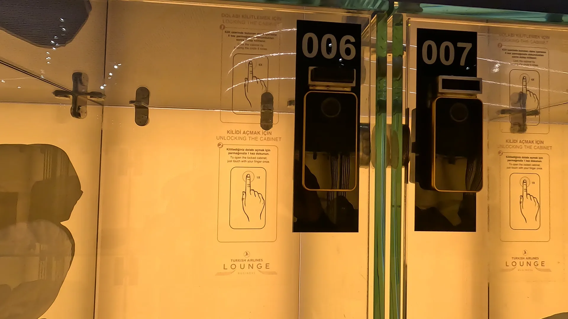 Transparent glass locker with instructions on how to lock and unlock the locker using your index finger/fingerprint, at Turkish Airlines Business Lounge, Istanbul Airport.